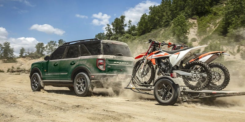 A 2023 Ford Bronco Sport towing motorbikes.