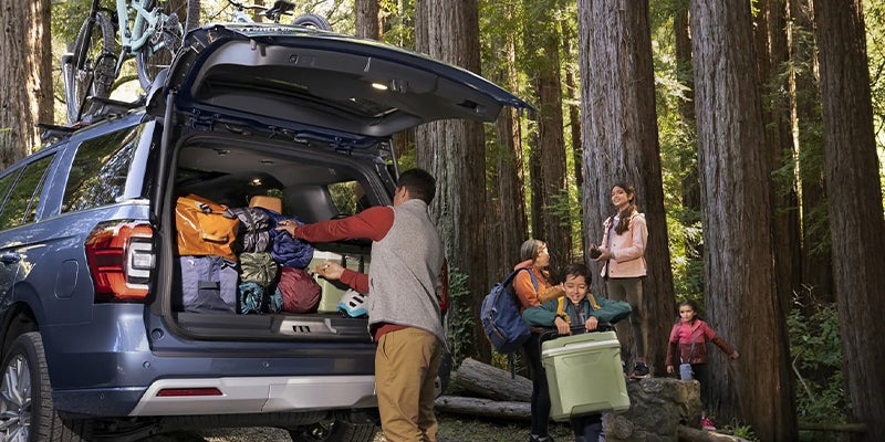 A family packing the trunk of their 2023 Ford Expedition.