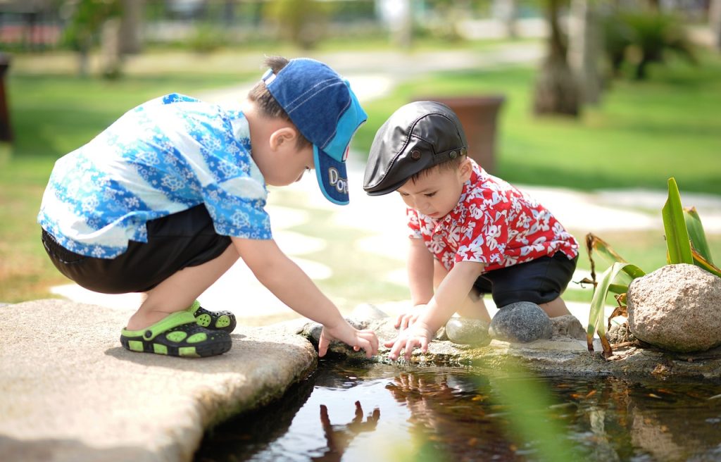 Two children playing at a park.