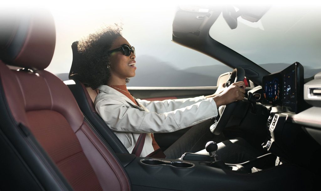 2024 Ford Mustang with a driver in the seat.