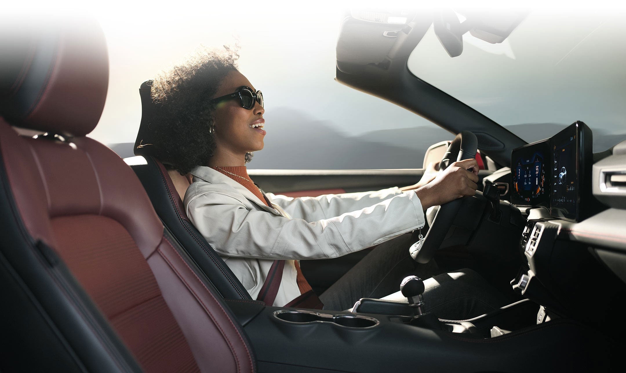 Person sitting in the driver’s seat of a 2024 Ford Mustang® convertible | Coughlin Ford of Pataskala in Pataskala OH